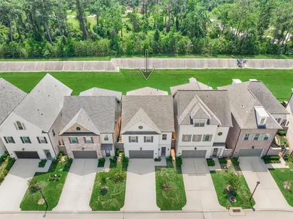 a view of house with garden space and car parked