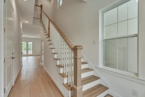 a view of entryway and hall with wooden floor