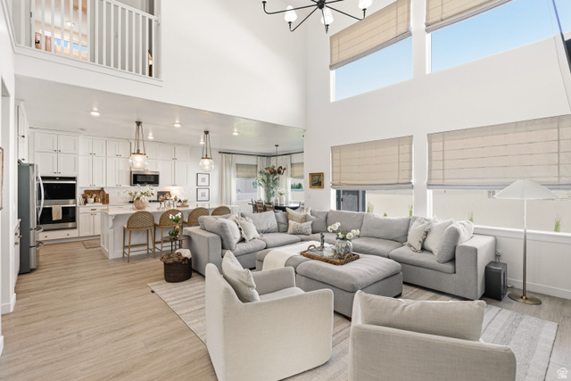 870 North Ada Loop Lehi, UT 84048 - Photo 6 of 51 Open-concept living space featuring high ceilings, wood-finish flooring, and a second-story interior balcony