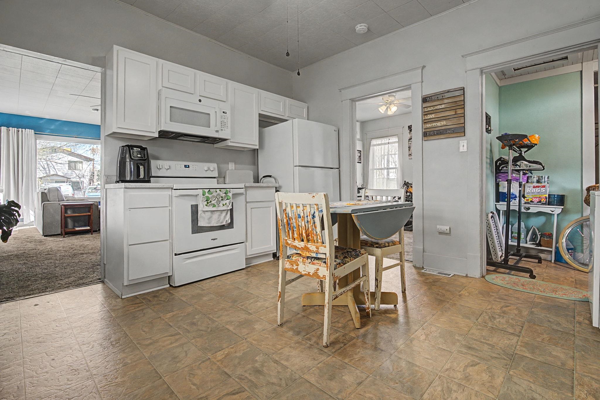 216 4th Street Clifton, CO 81520 - Photo 6 of 17 a kitchen with a table chairs refrigerator and cabinets