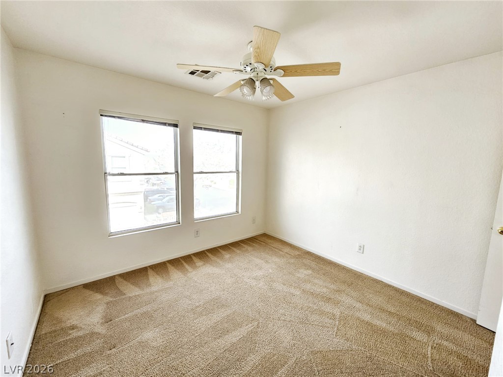 1663 Lefty Garcia Way Henderson, NV 89002 - Photo 10 of 31 Well-lit room with plush carpeting and a modern ceiling fan for optimal comfort.