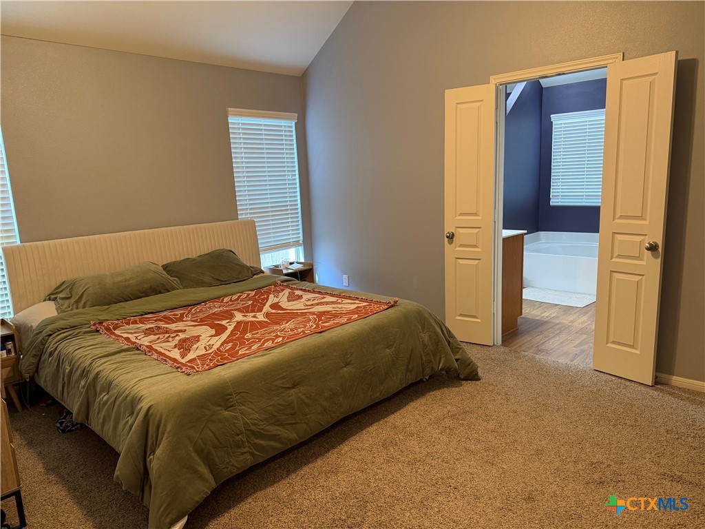 1126 Neuberry Cliffe Temple, TX 76502 - Photo 11 of 19 a bedroom with a bed and a dresser