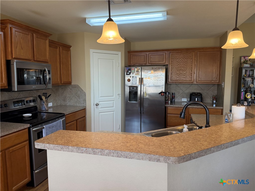 1126 Neuberry Cliffe Temple, TX 76502 - Photo 5 of 19 a kitchen with stainless steel appliances granite countertop a sink a stove and a refrigerator