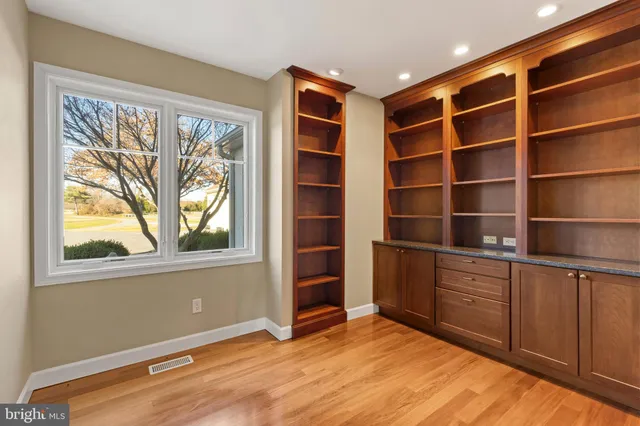 a view of an empty room with a fireplace and a window