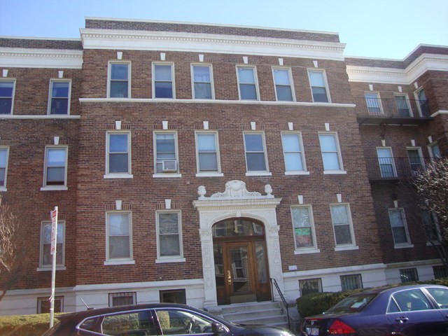a front view of a brick building with many windows