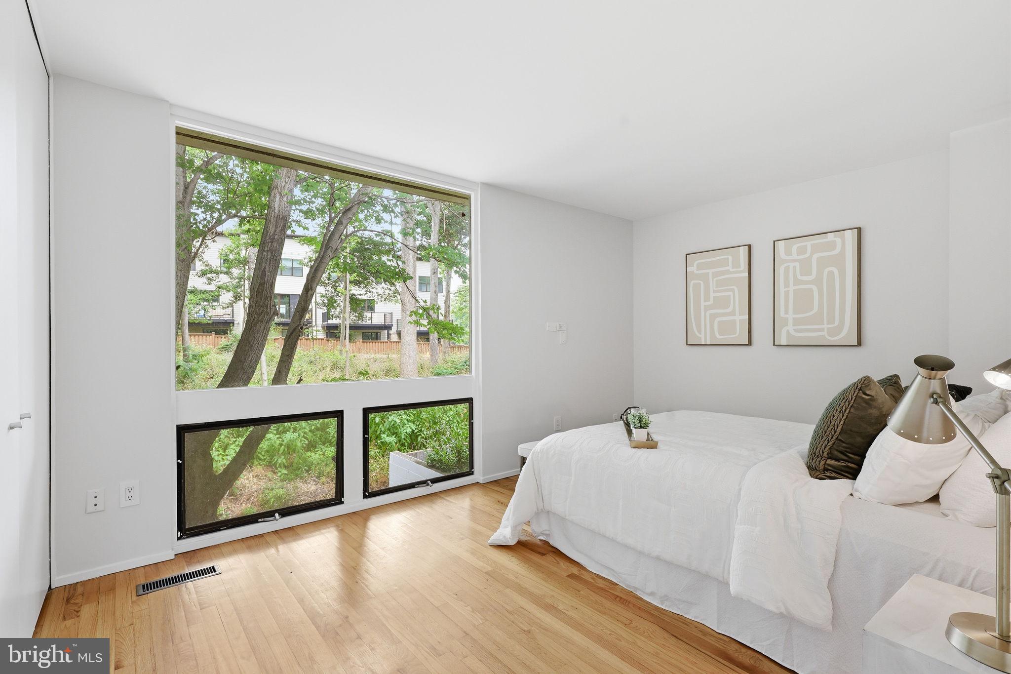 11510 Maple Ridge Road Reston, VA 20190 - Photo 4 of 43 a bedroom with a bed and a large window