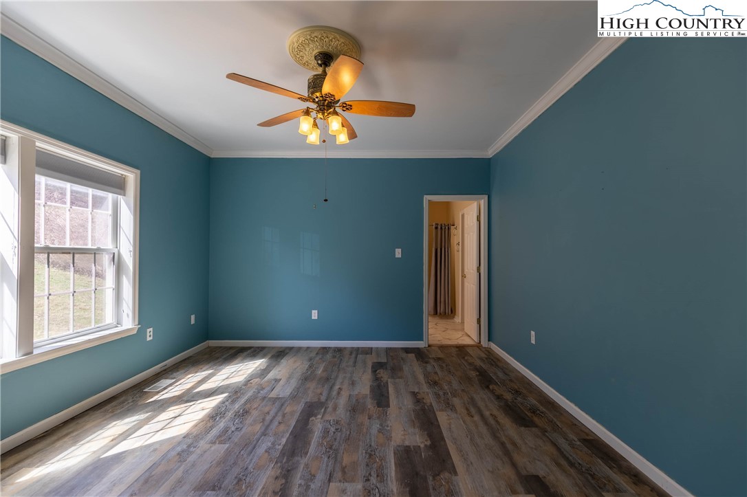 449 Meadow Ridge Drive Jefferson, NC 28640 - Photo 13 of 37 a view of empty room with wooden floor and fan