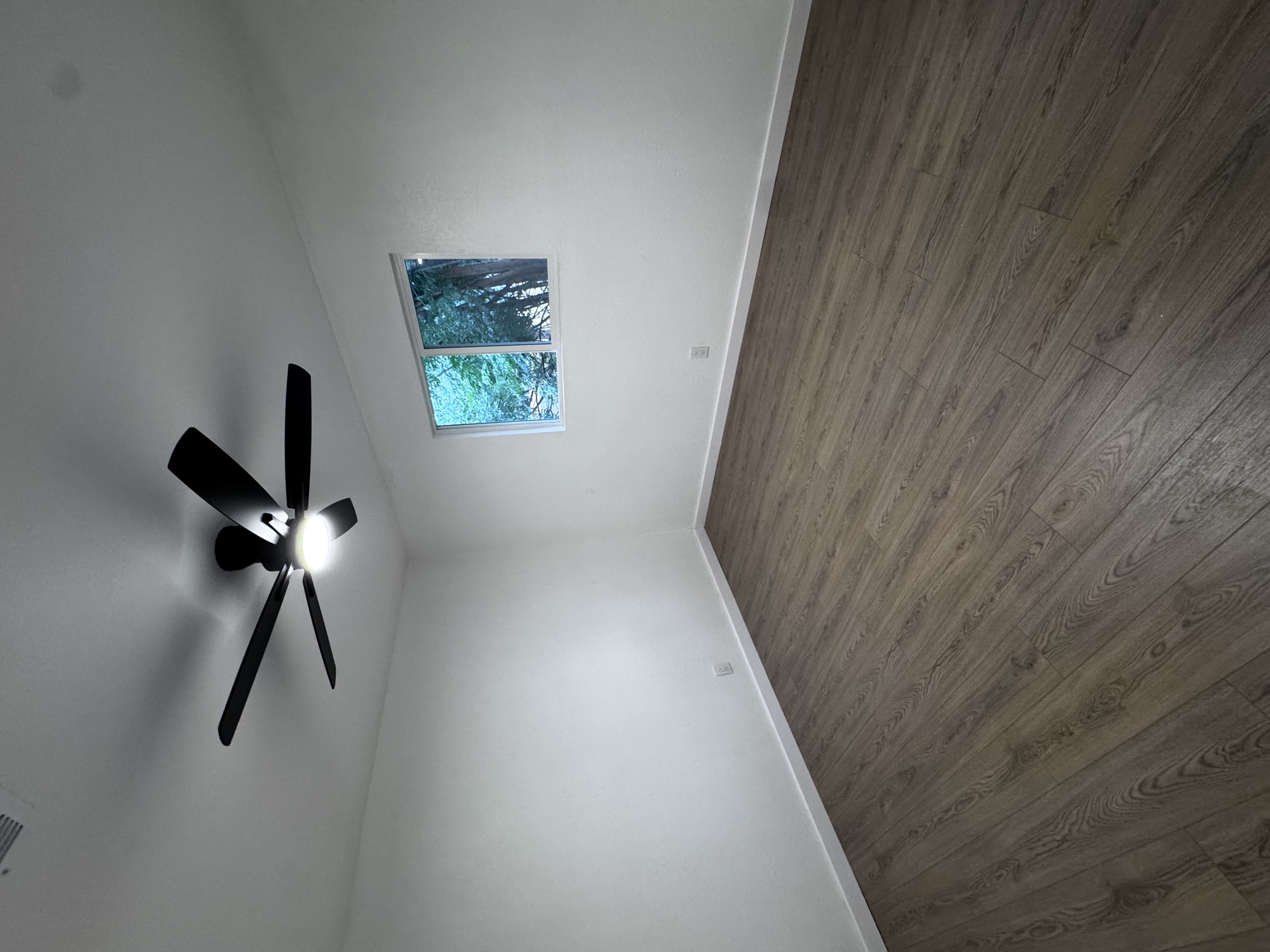 4908 Hawk Cove, Unit 2 Austin, TX 78745 - Photo 16 of 17 Hardwood-style flooring and a modern ceiling fan define this versatile bedroom.