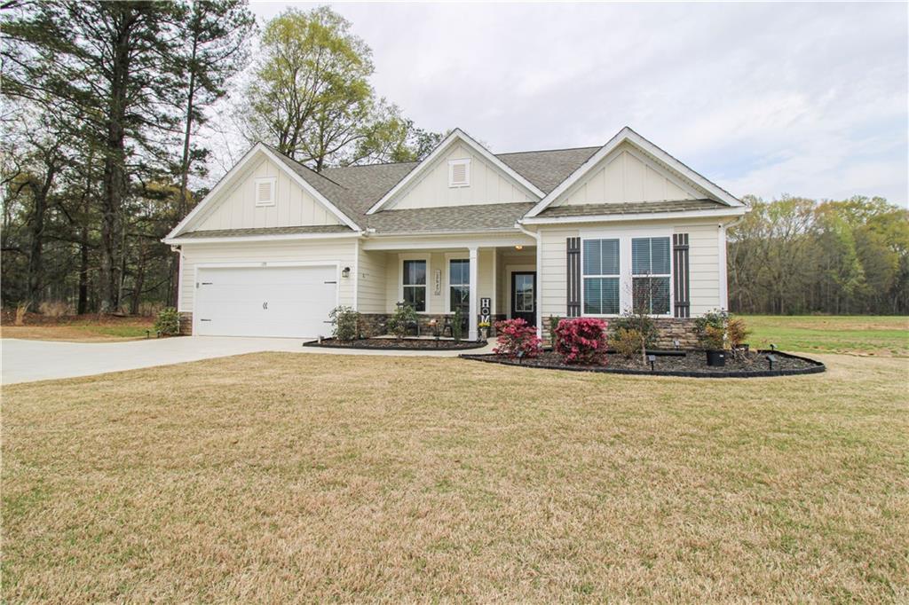 a view of a house with floor to ceiling windows and yard