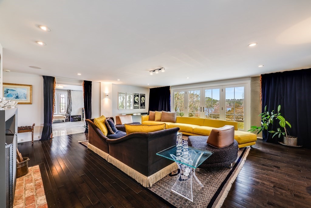75 Great Hill Road Sandwich, MA 02563 - Photo 12 of 42 a living room with furniture flat screen tv and a large window