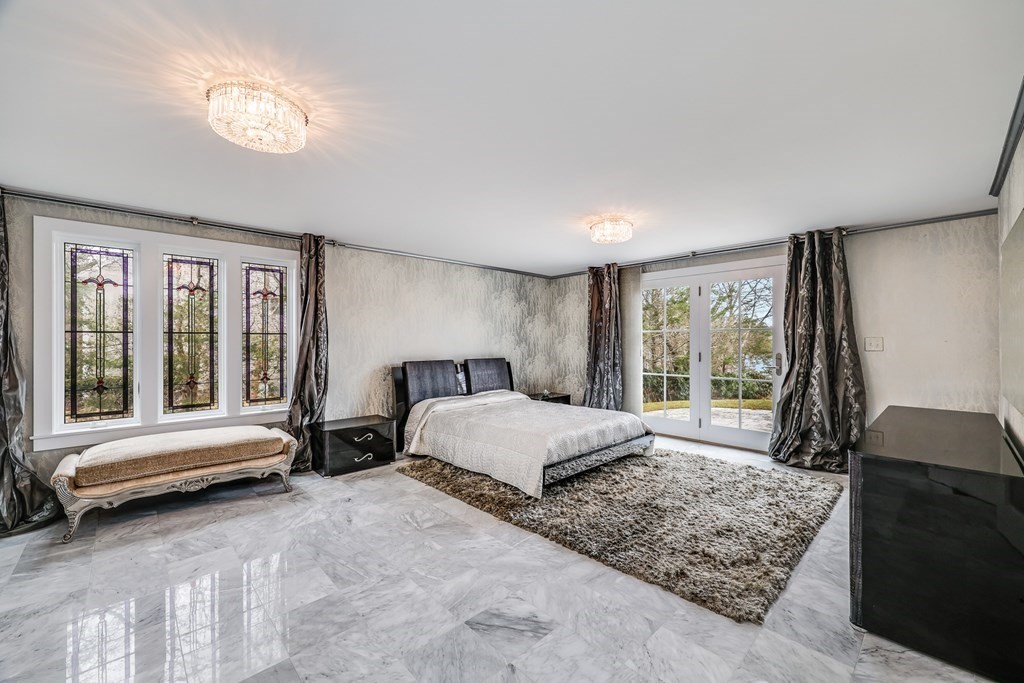 75 Great Hill Road Sandwich, MA 02563 - Photo 13 of 42 a spacious bedroom with a large bed and a couch