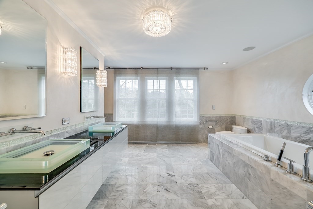 75 Great Hill Road Sandwich, MA 02563 - Photo 16 of 42 a spacious bathroom with a tub sink and mirror