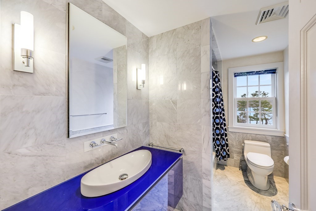 75 Great Hill Road Sandwich, MA 02563 - Photo 25 of 42 a bathroom with a toilet a sink and a mirror