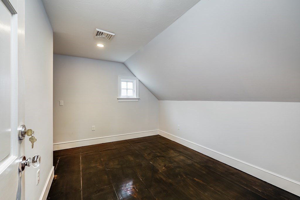 75 Great Hill Road Sandwich, MA 02563 - Photo 27 of 42 an empty room with wooden floor and windows