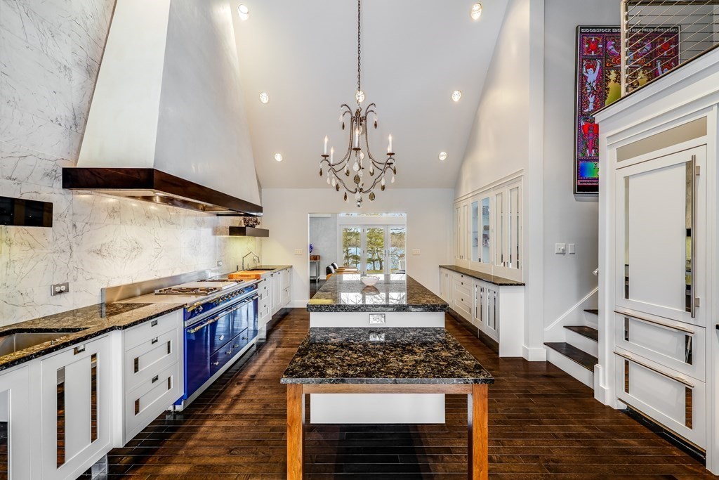 75 Great Hill Road Sandwich, MA 02563 - Photo 3 of 42 a large kitchen with stainless steel appliances granite countertop a stove and a wooden floors