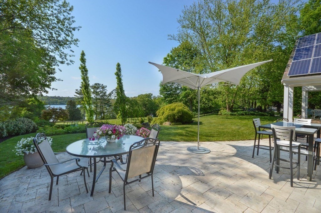 75 Great Hill Road Sandwich, MA 02563 - Photo 35 of 42 a view of a patio with a table and chairs