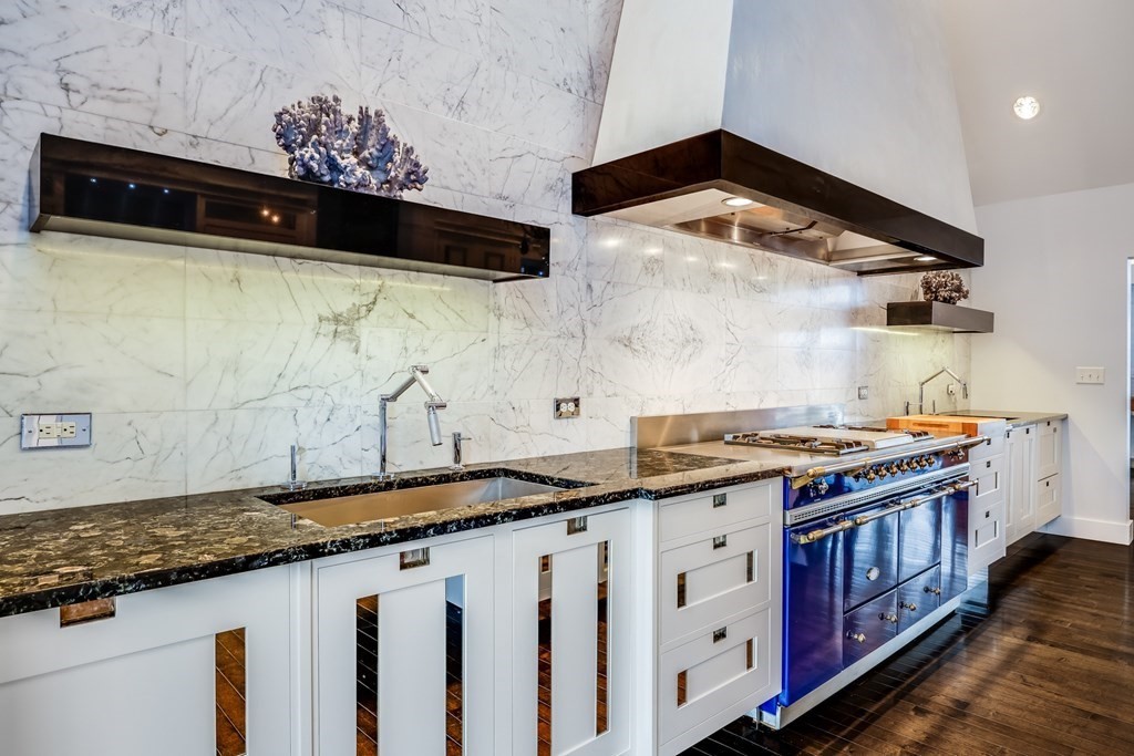 75 Great Hill Road Sandwich, MA 02563 - Photo 5 of 42 a kitchen with granite countertop a stove a sink and a microwave