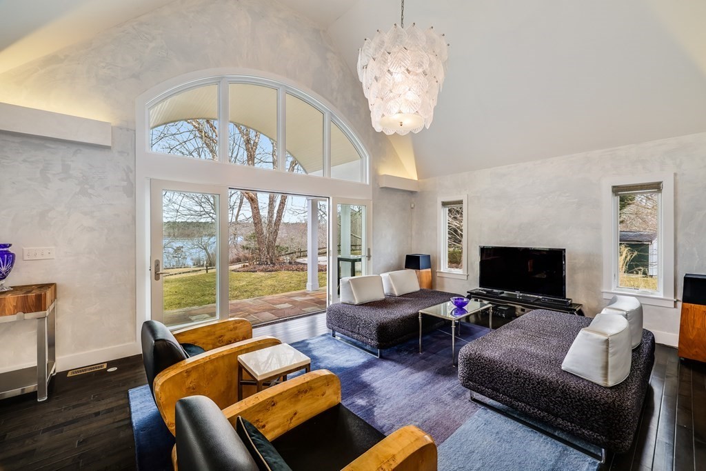 75 Great Hill Road Sandwich, MA 02563 - Photo 6 of 42 a living room with furniture chandelier and a flat screen tv