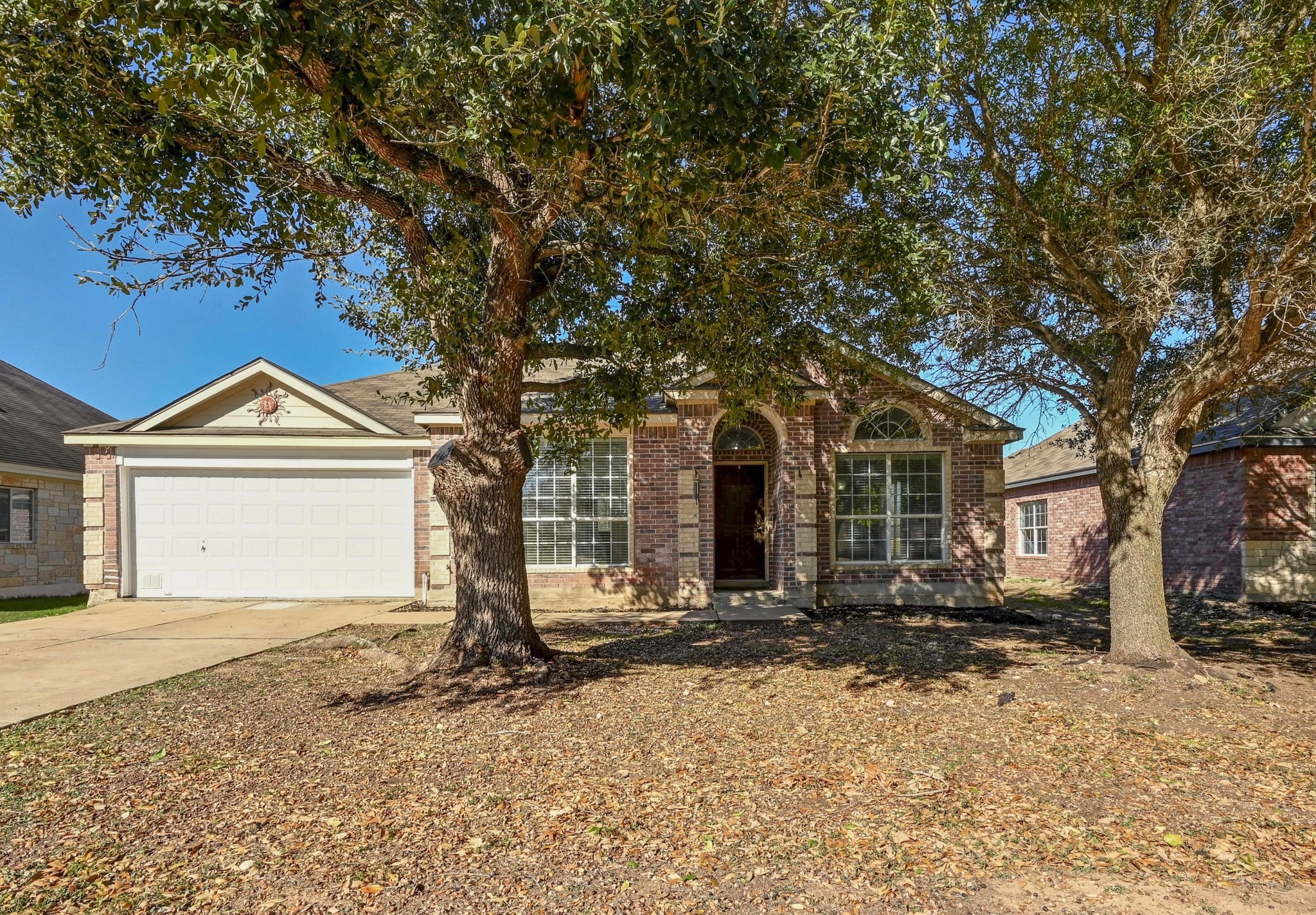 198 Valruth Drive Kyle, TX 78640 - Photo 1 of 32 View of front facade with driveway, brick siding, and an attached garage