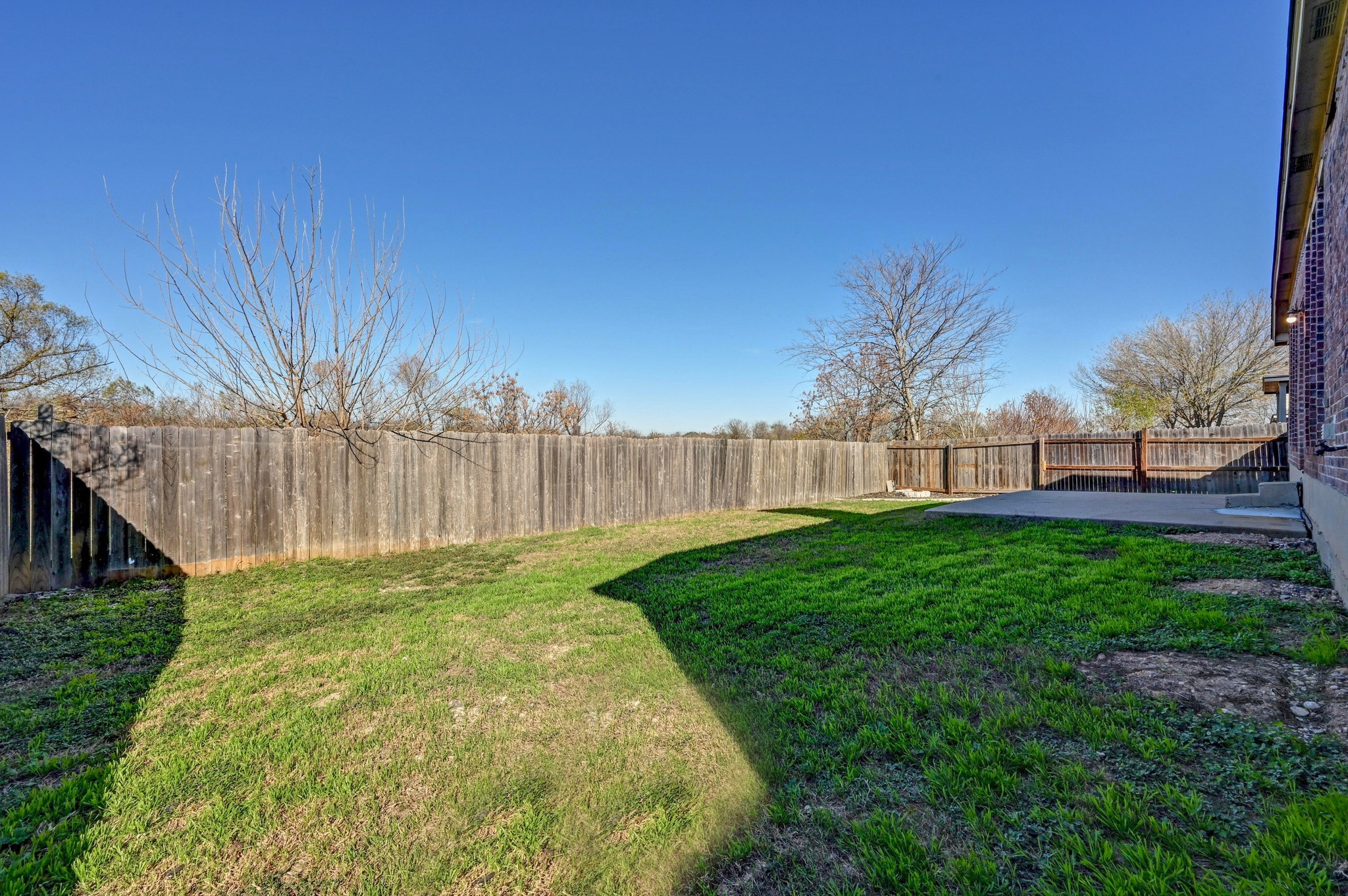 198 Valruth Drive Kyle, TX 78640 - Photo 32 of 32 Fenced backyard with a patio