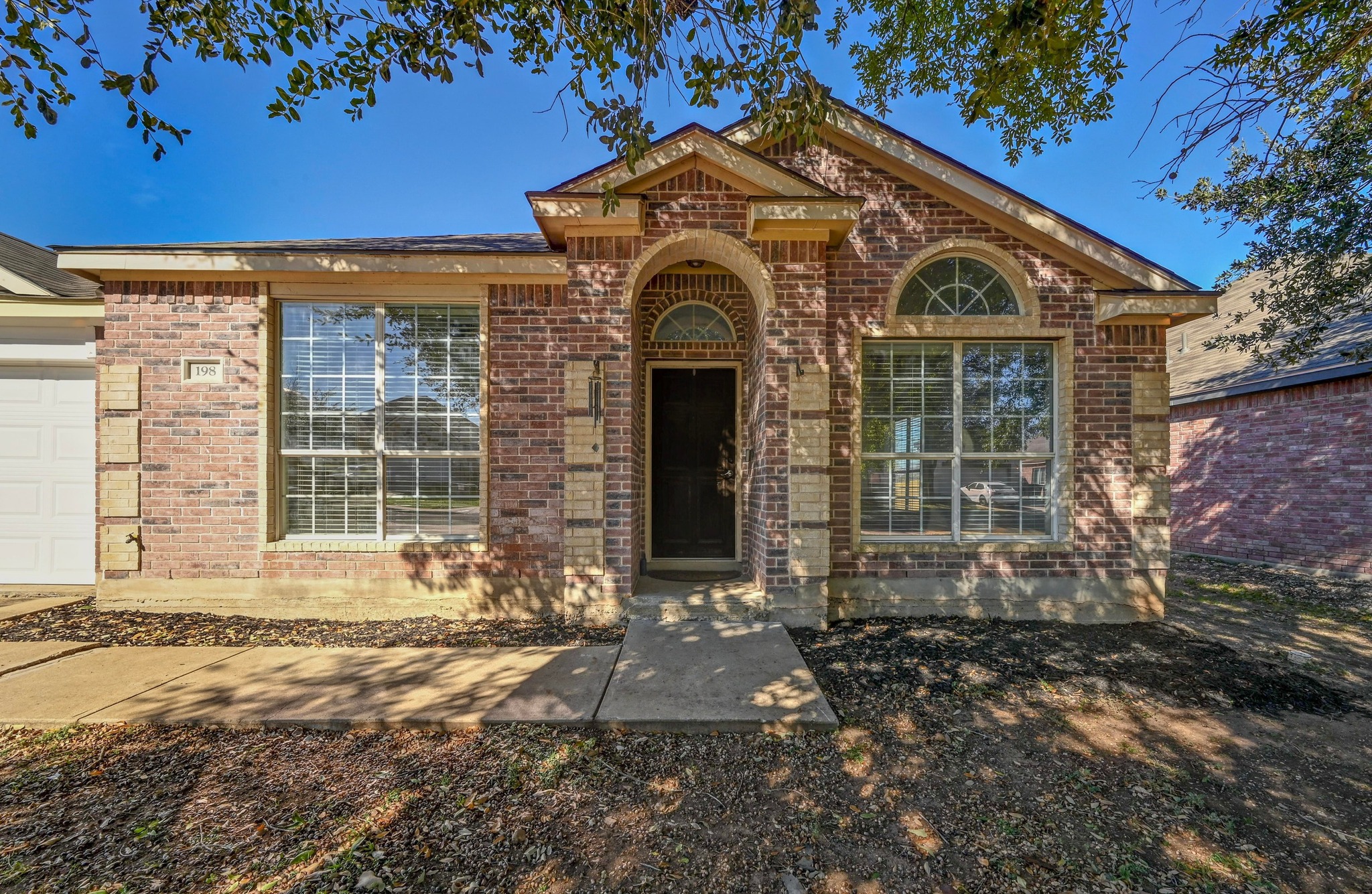 198 Valruth Drive Kyle, TX 78640 - Photo 4 of 32 View of front facade with brick siding and an attached garage