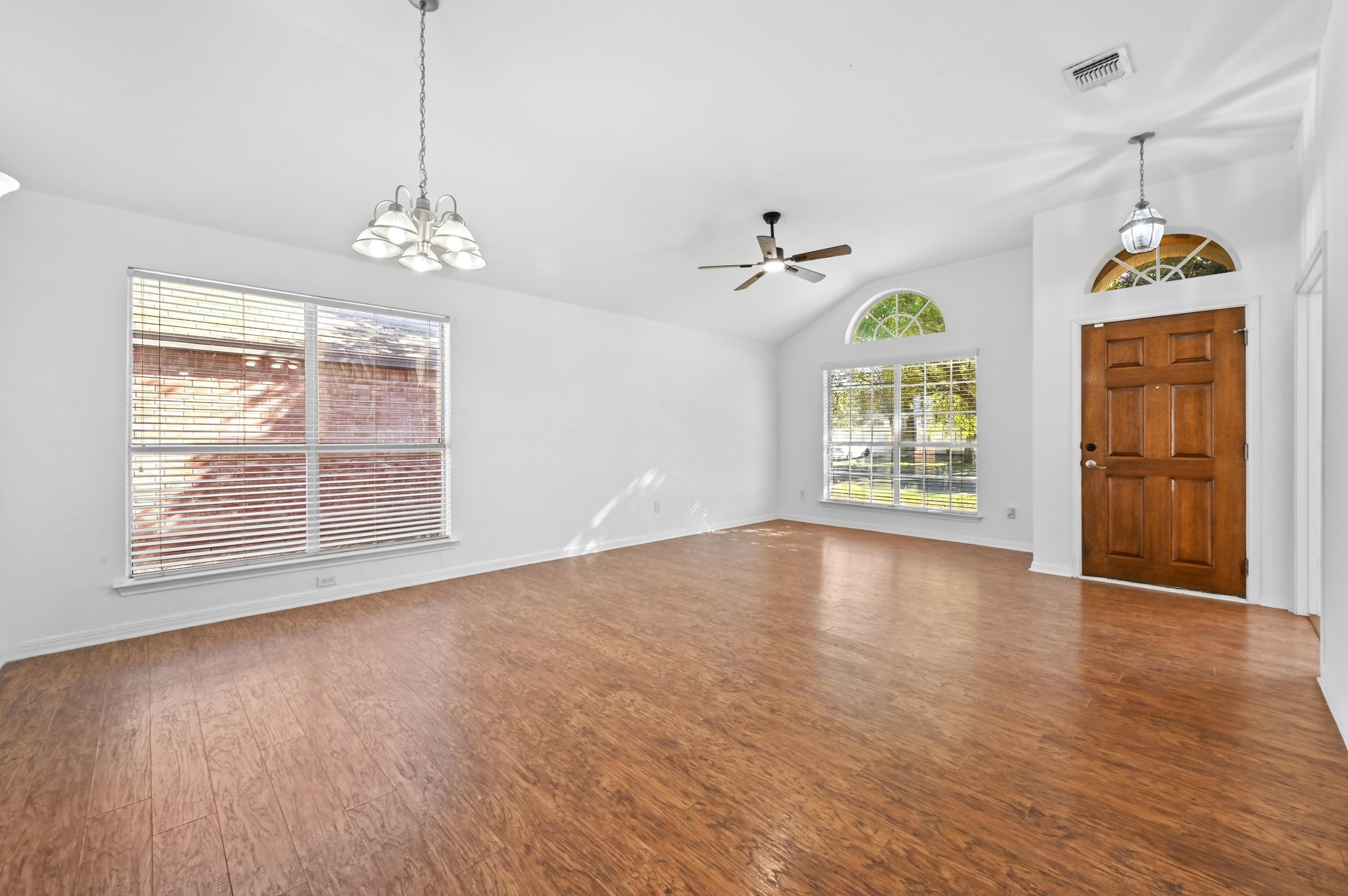 198 Valruth Drive Kyle, TX 78640 - Photo 7 of 32 Entryway featuring lofted ceiling, a chandelier, dark wood-style floors, and a ceiling fan