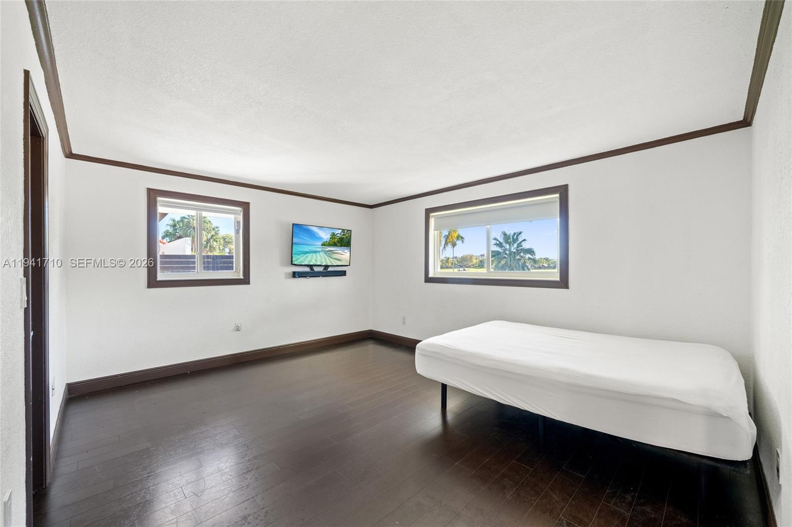 9461 Southwest 128th Street Miami, FL 33176 - Photo 12 of 24 a view of a room with window and wooden floor