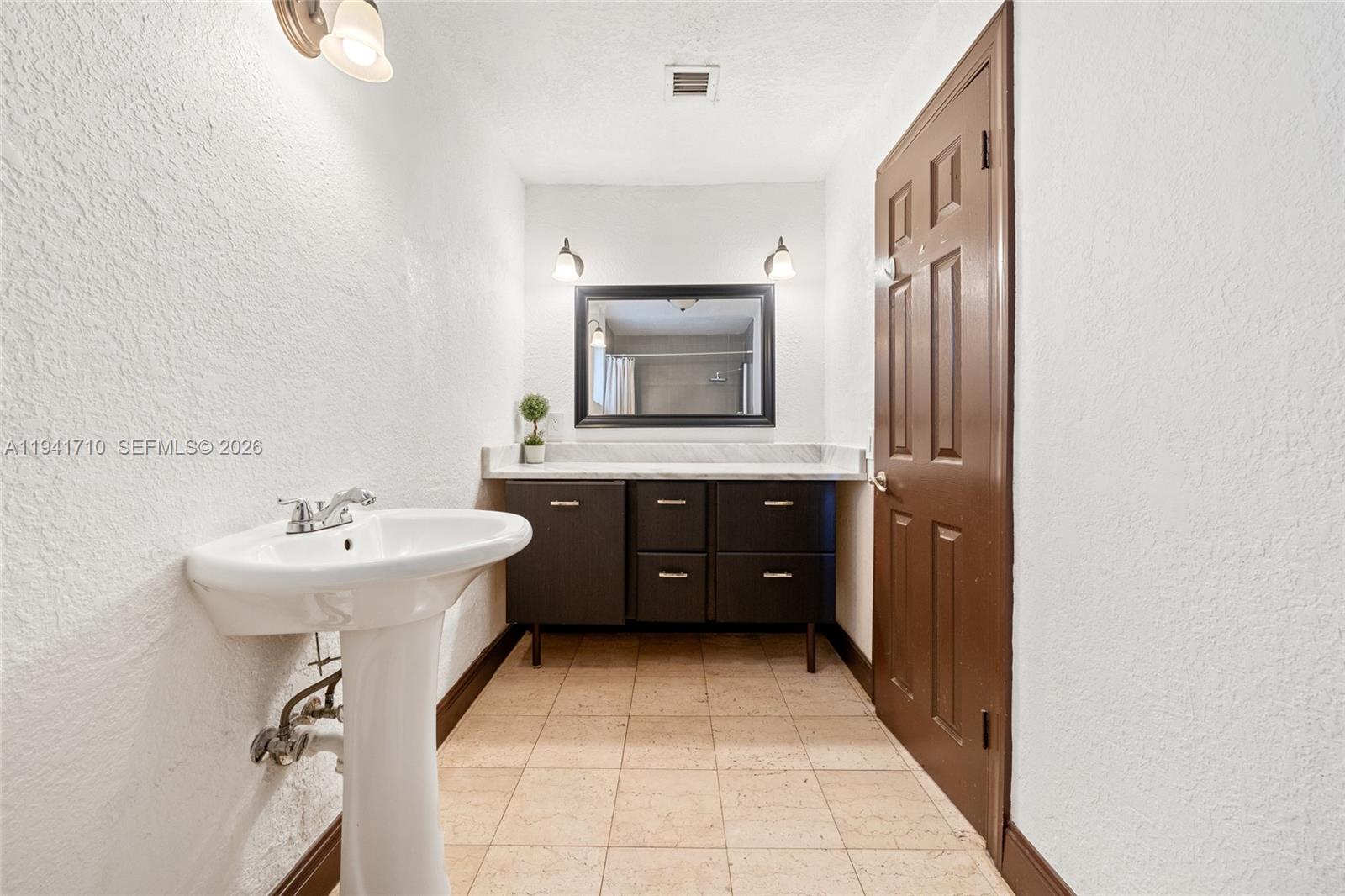 9461 Southwest 128th Street Miami, FL 33176 - Photo 13 of 24 a bathroom with a sink and a mirror