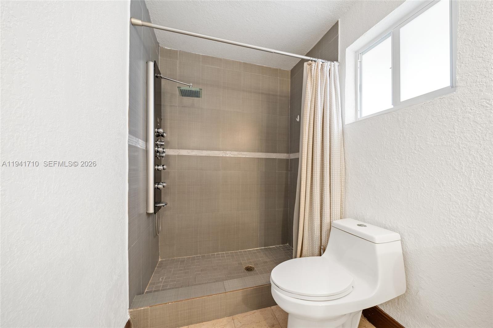 9461 Southwest 128th Street Miami, FL 33176 - Photo 14 of 24 a white toilet sitting next to a bathroom sink