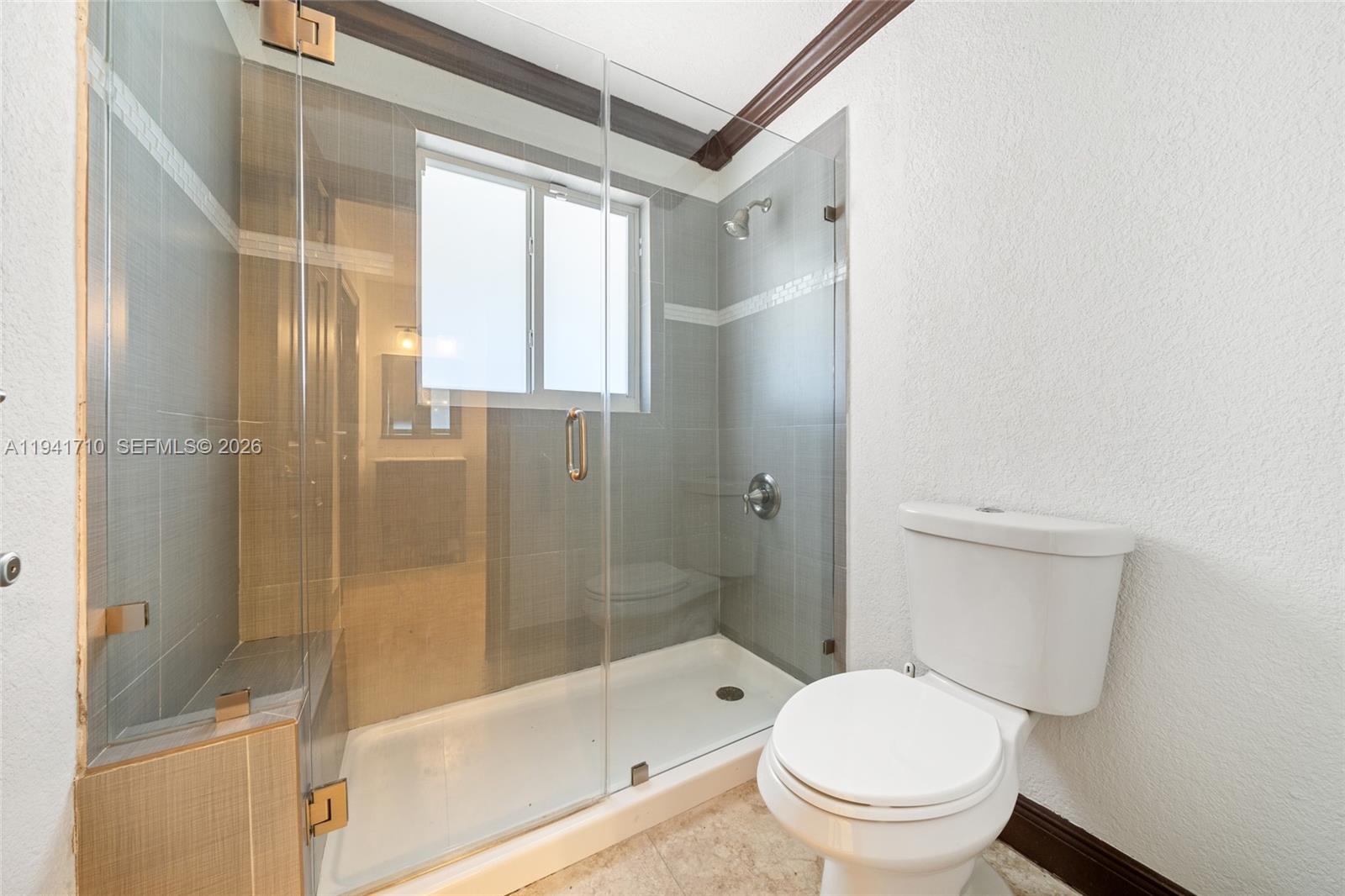 9461 Southwest 128th Street Miami, FL 33176 - Photo 16 of 24 a bathroom with a granite countertop toilet a sink and shower