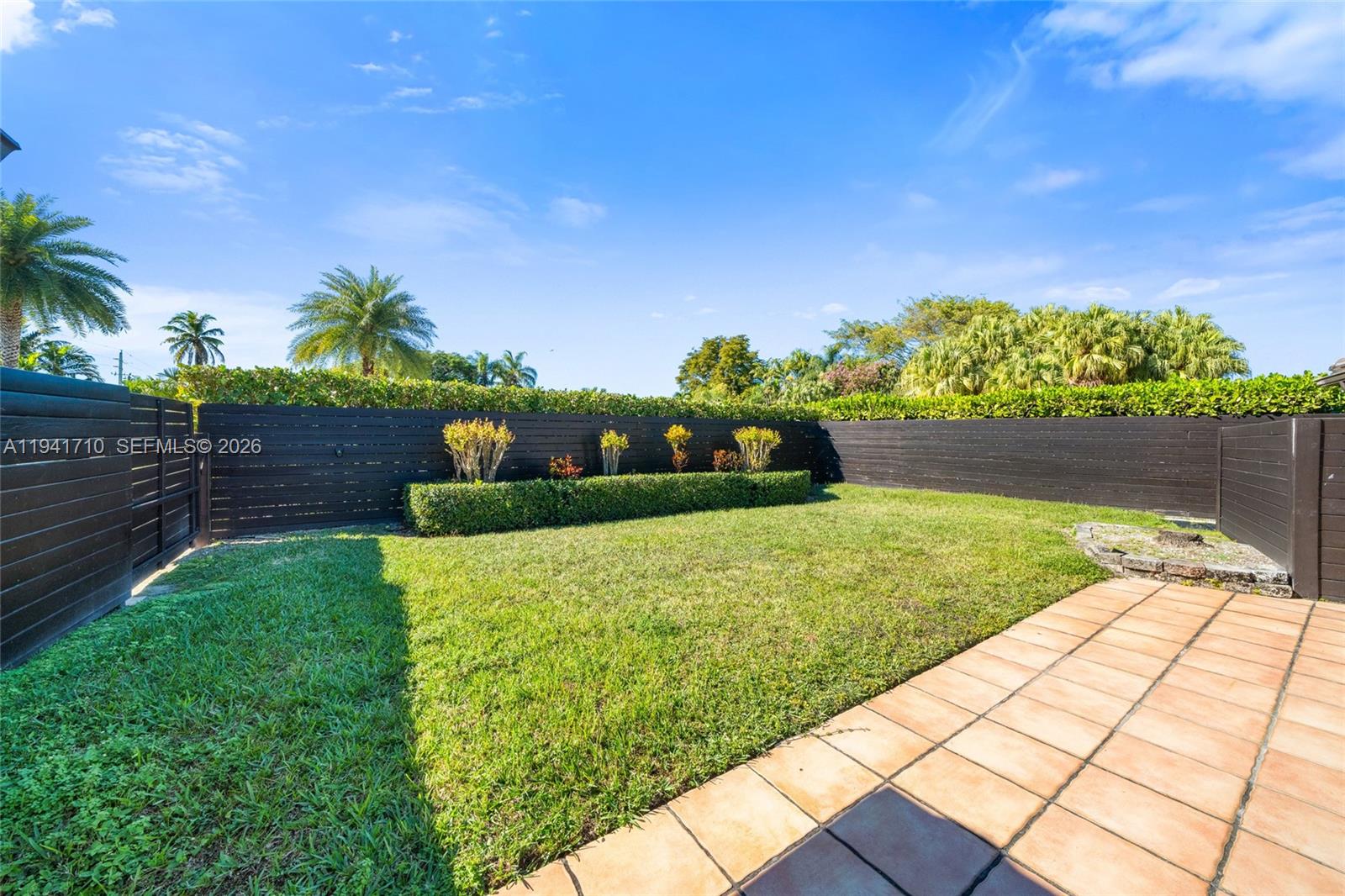 9461 Southwest 128th Street Miami, FL 33176 - Photo 18 of 24 a view of a garden with wooden fence