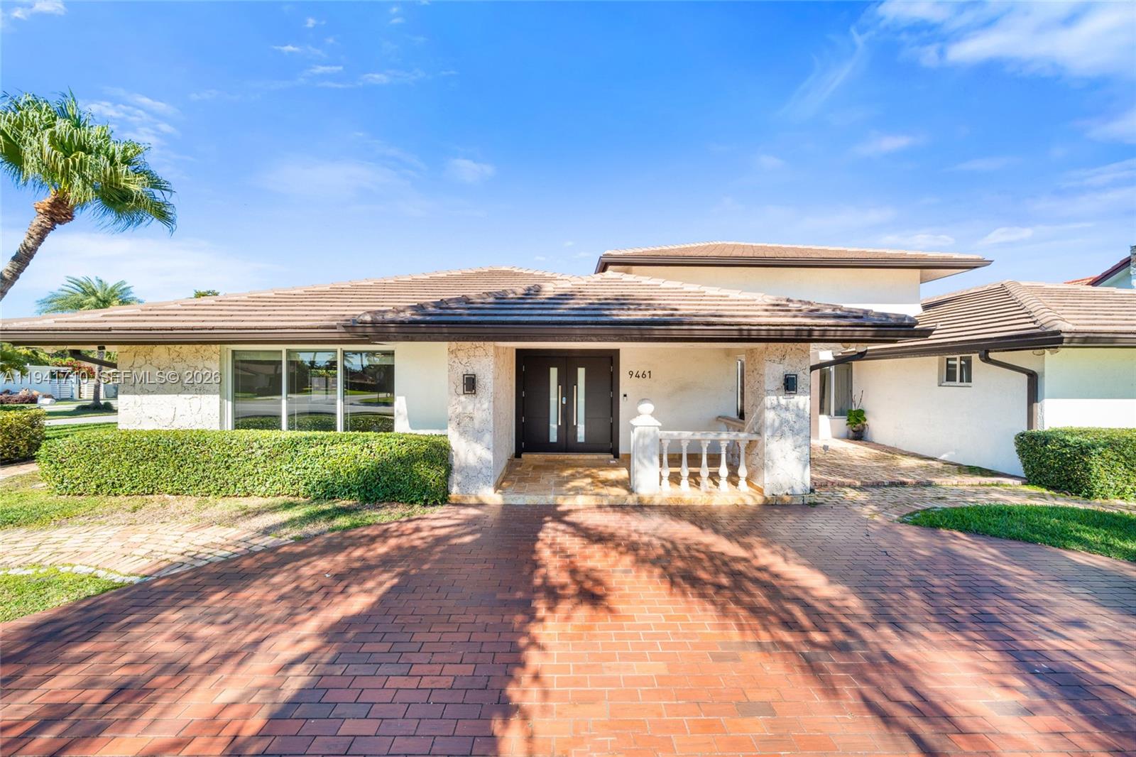 9461 Southwest 128th Street Miami, FL 33176 - Photo 2 of 24 a front view of a house with a yard and outdoor seating