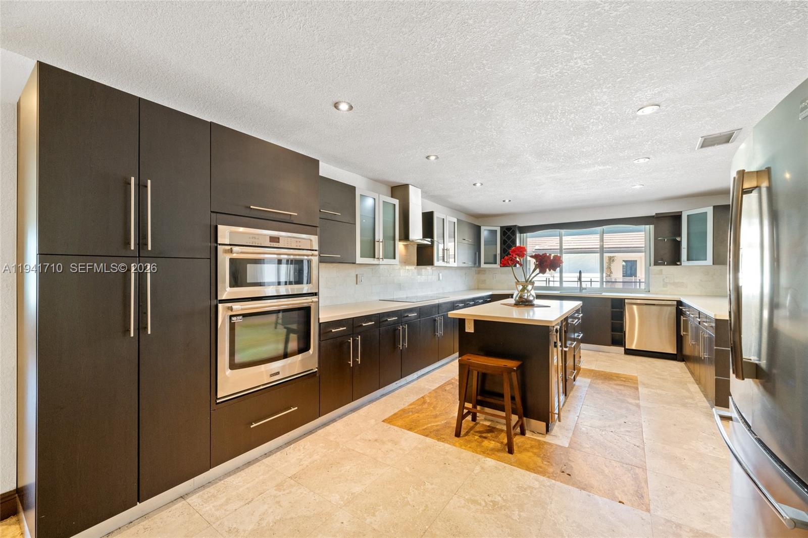 9461 Southwest 128th Street Miami, FL 33176 - Photo 6 of 24 a kitchen with a refrigerator and a stove top oven