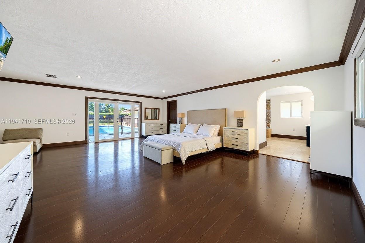 9461 Southwest 128th Street Miami, FL 33176 - Photo 8 of 24 a bedroom with a bed and wooden floor