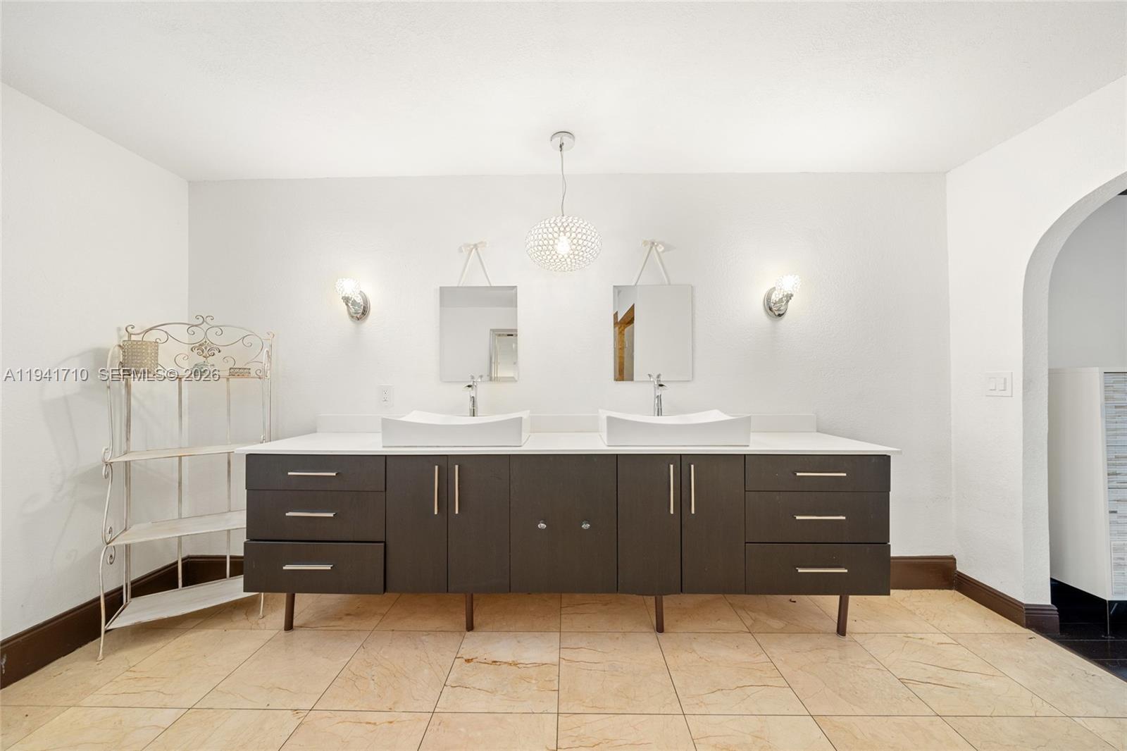 9461 Southwest 128th Street Miami, FL 33176 - Photo 9 of 24 a bathroom with a sink vanity and mirror
