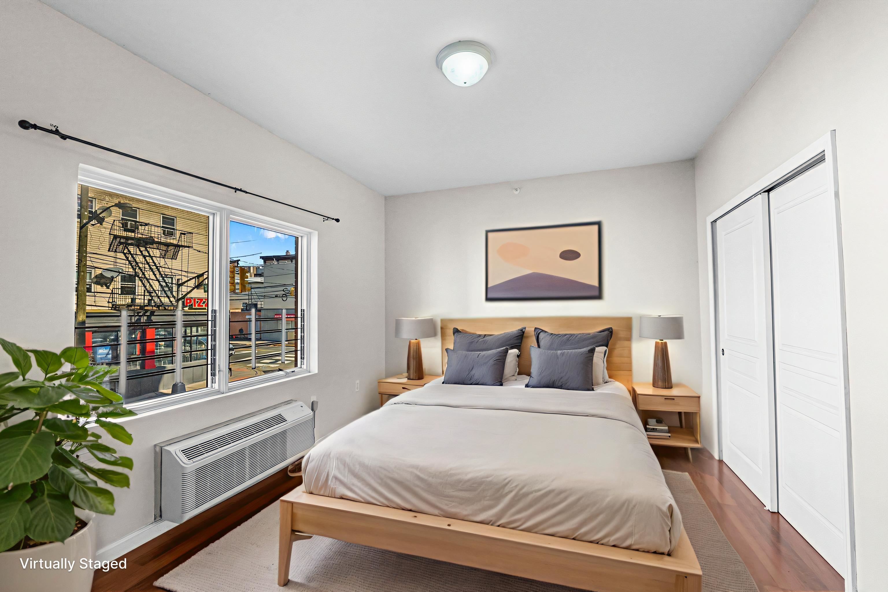 845 Newark Avenue, Unit 3B Jersey City, NJ 07306 - Photo 11 of 26 a bedroom with a large bed and a potted plant