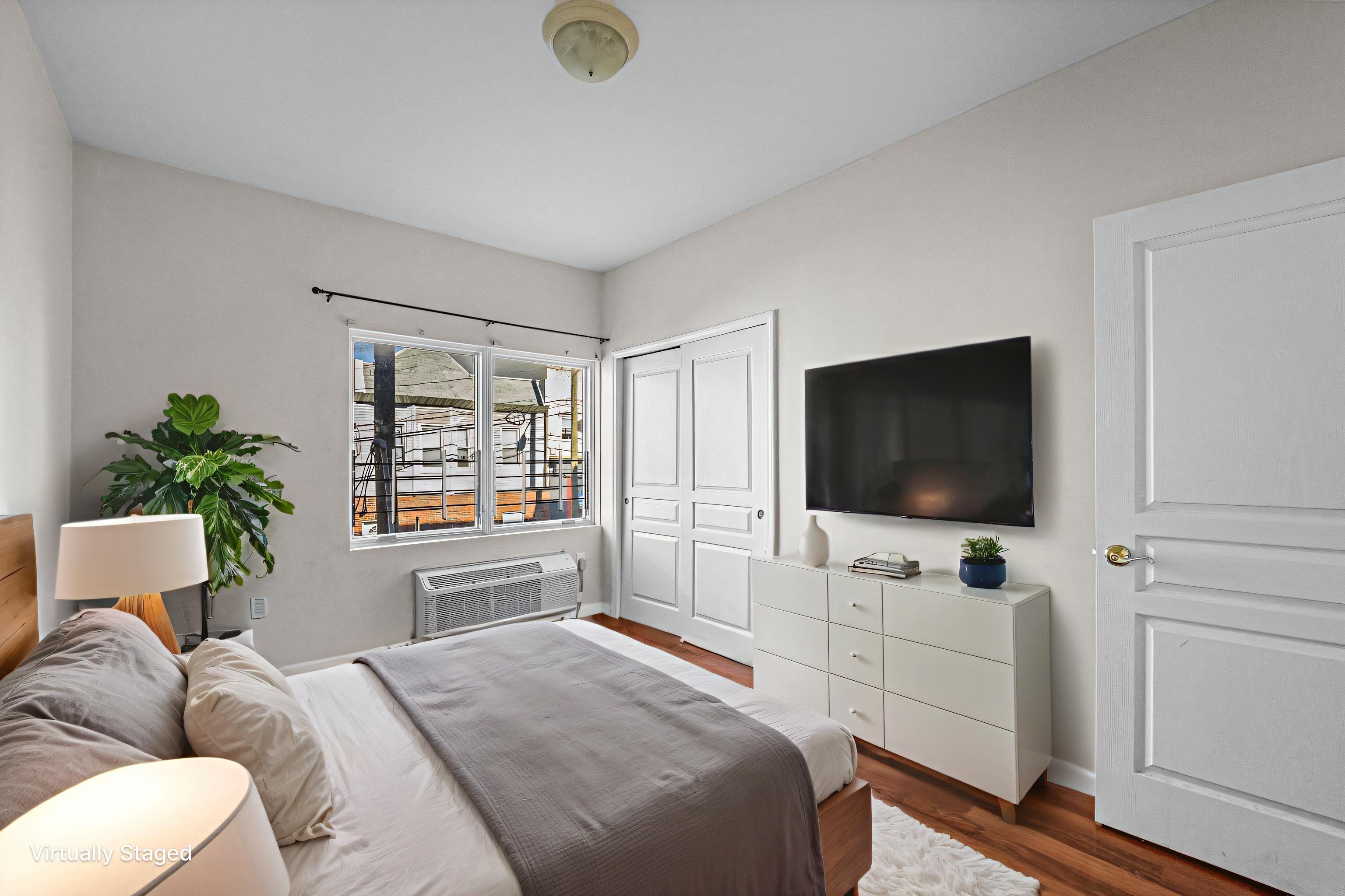 845 Newark Avenue, Unit 3B Jersey City, NJ 07306 - Photo 13 of 26 a bedroom with a bed and a flat screen tv