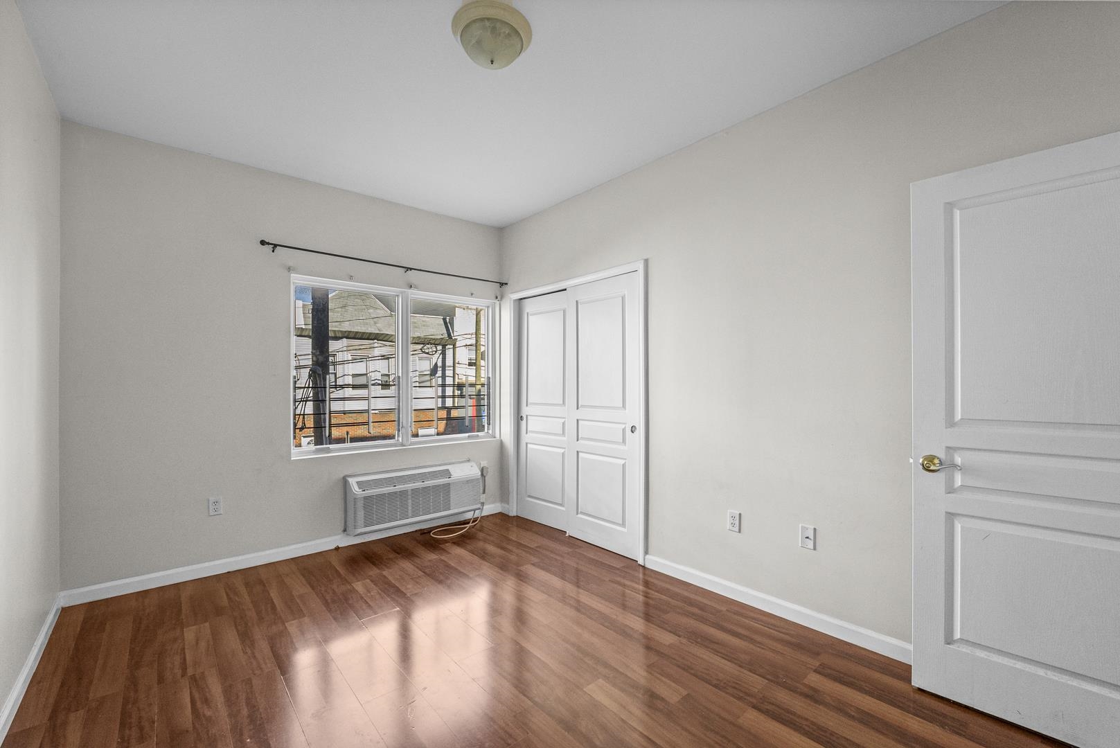 845 Newark Avenue, Unit 3B Jersey City, NJ 07306 - Photo 14 of 26 an empty room with windows