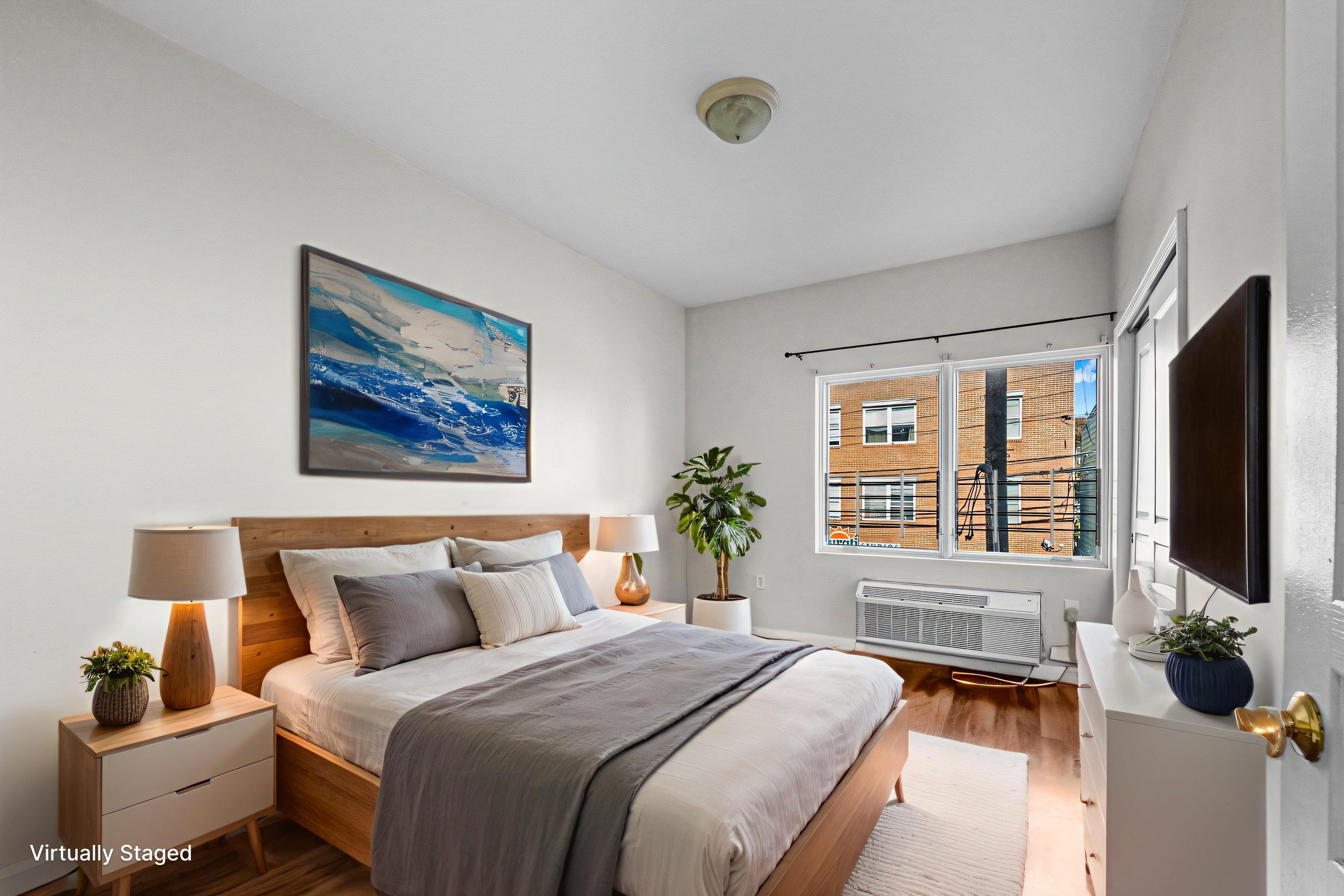 845 Newark Avenue, Unit 3B Jersey City, NJ 07306 - Photo 15 of 26 a bedroom with bed and flat screen tv