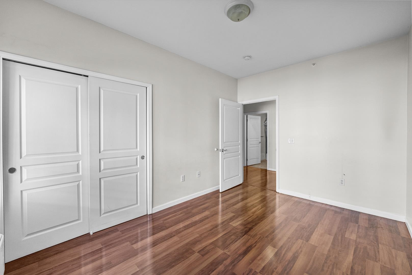 845 Newark Avenue, Unit 3B Jersey City, NJ 07306 - Photo 20 of 26 a view of an empty room with wooden floor