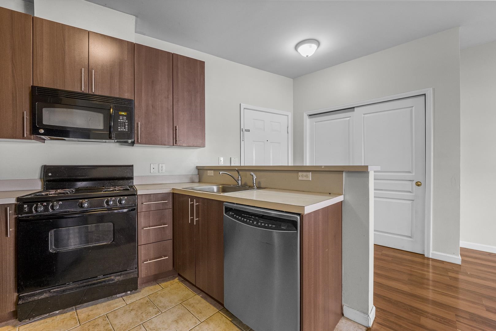845 Newark Avenue, Unit 3B Jersey City, NJ 07306 - Photo 21 of 26 a kitchen with a stove and a microwave