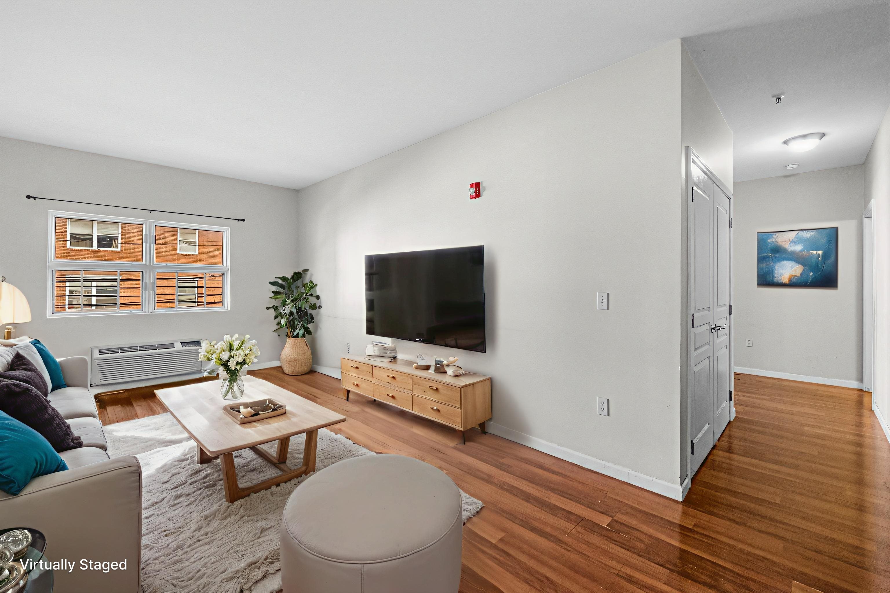 845 Newark Avenue, Unit 3B Jersey City, NJ 07306 - Photo 3 of 26 a living room with furniture and a flat screen tv