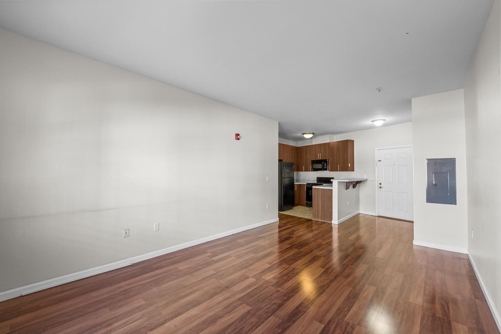845 Newark Avenue, Unit 3B Jersey City, NJ 07306 - Photo 5 of 26 a view of kitchen with wooden floor and electronic appliances