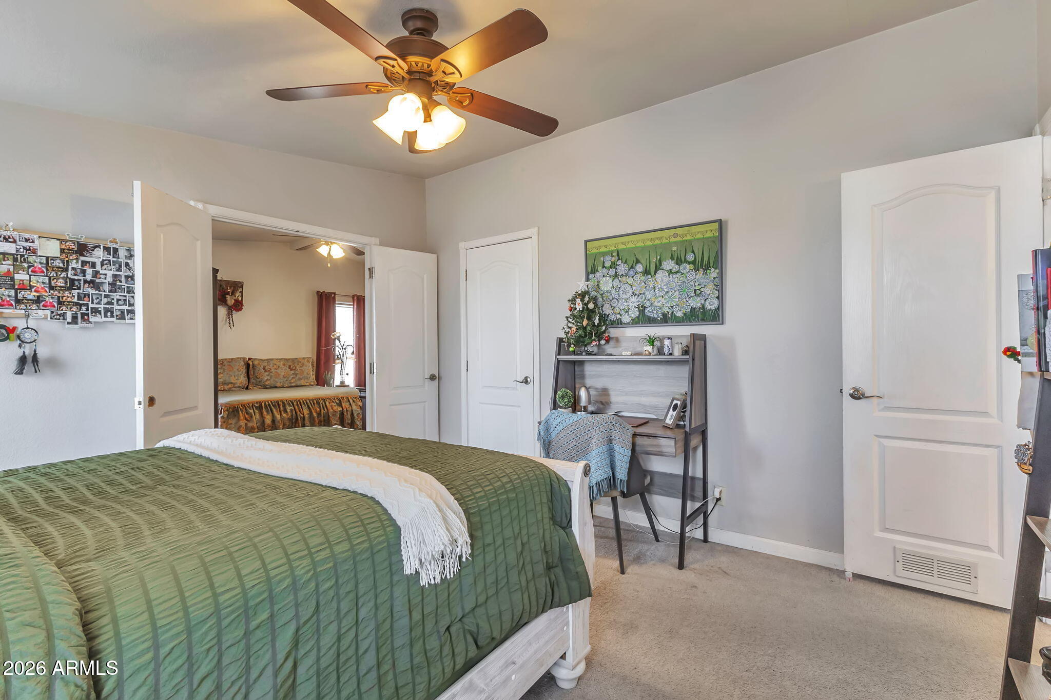 1236 West Judd Road San Tan Valley, AZ 85144 - Photo 11 of 28 a bedroom with a bed and a chandelier