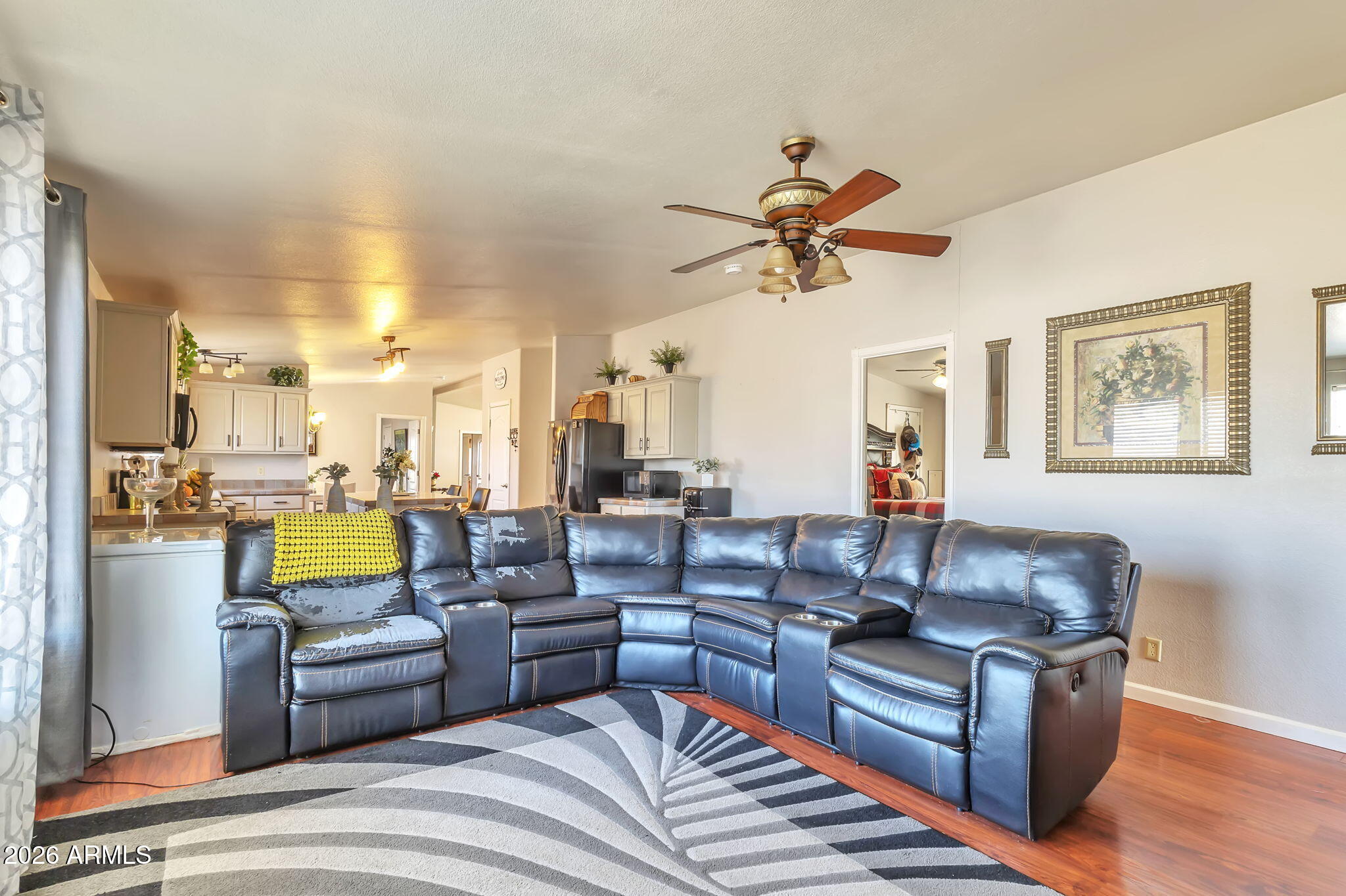1236 West Judd Road San Tan Valley, AZ 85144 - Photo 18 of 28 a living room with furniture ceiling fan and a rug