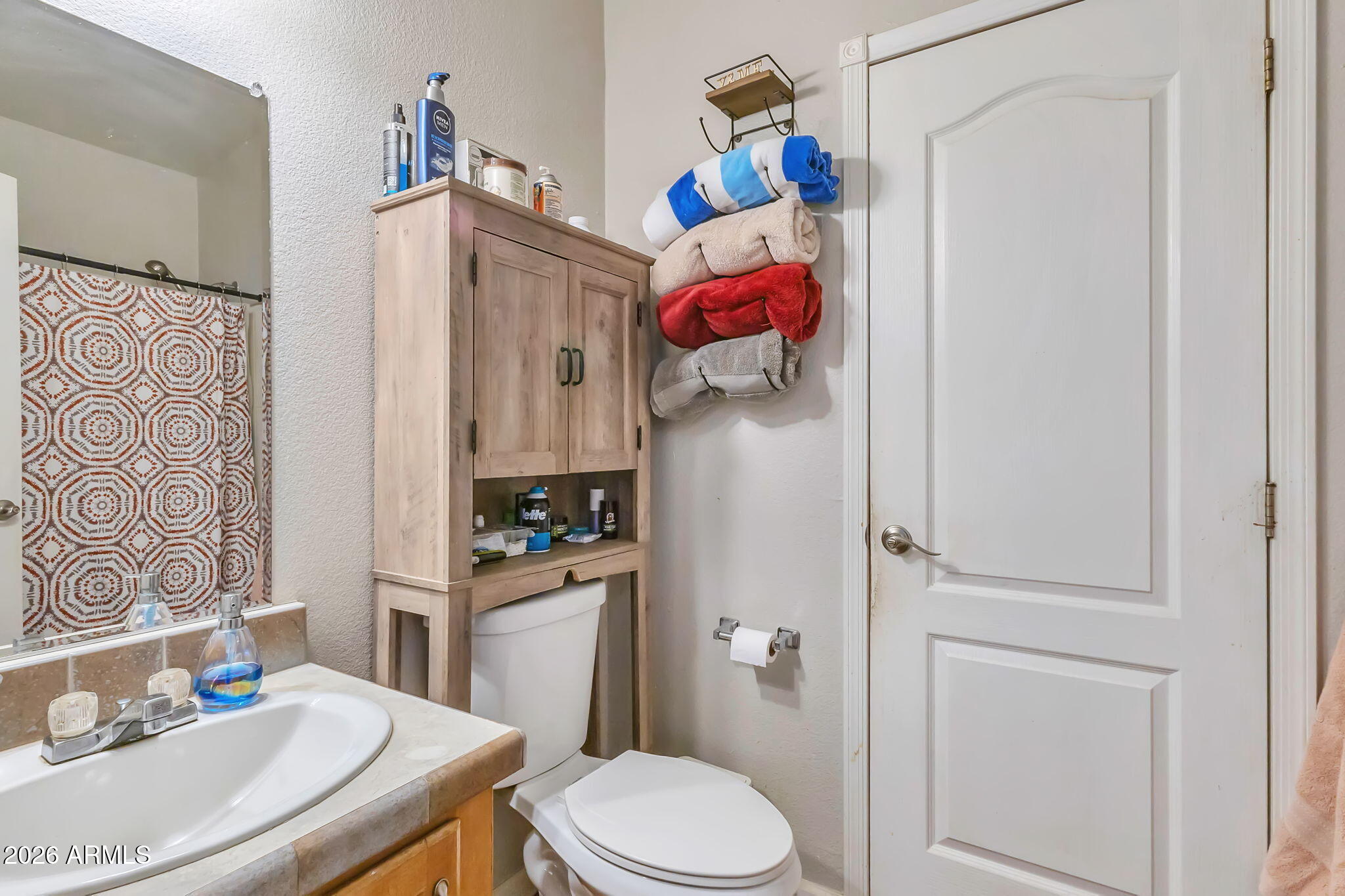 1236 West Judd Road San Tan Valley, AZ 85144 - Photo 20 of 28 a bathroom with a sink a toilet and shower curtain
