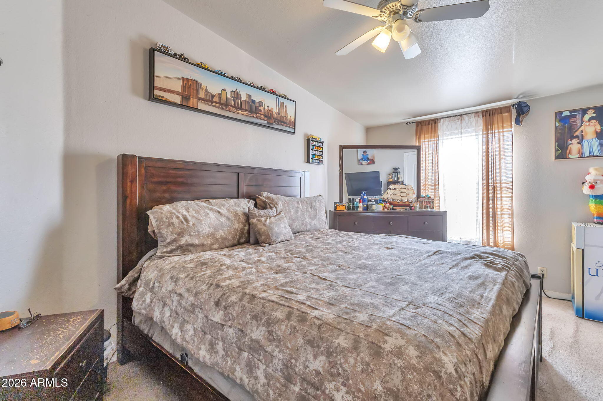 1236 West Judd Road San Tan Valley, AZ 85144 - Photo 21 of 28 a bedroom with a large bed and a chandelier