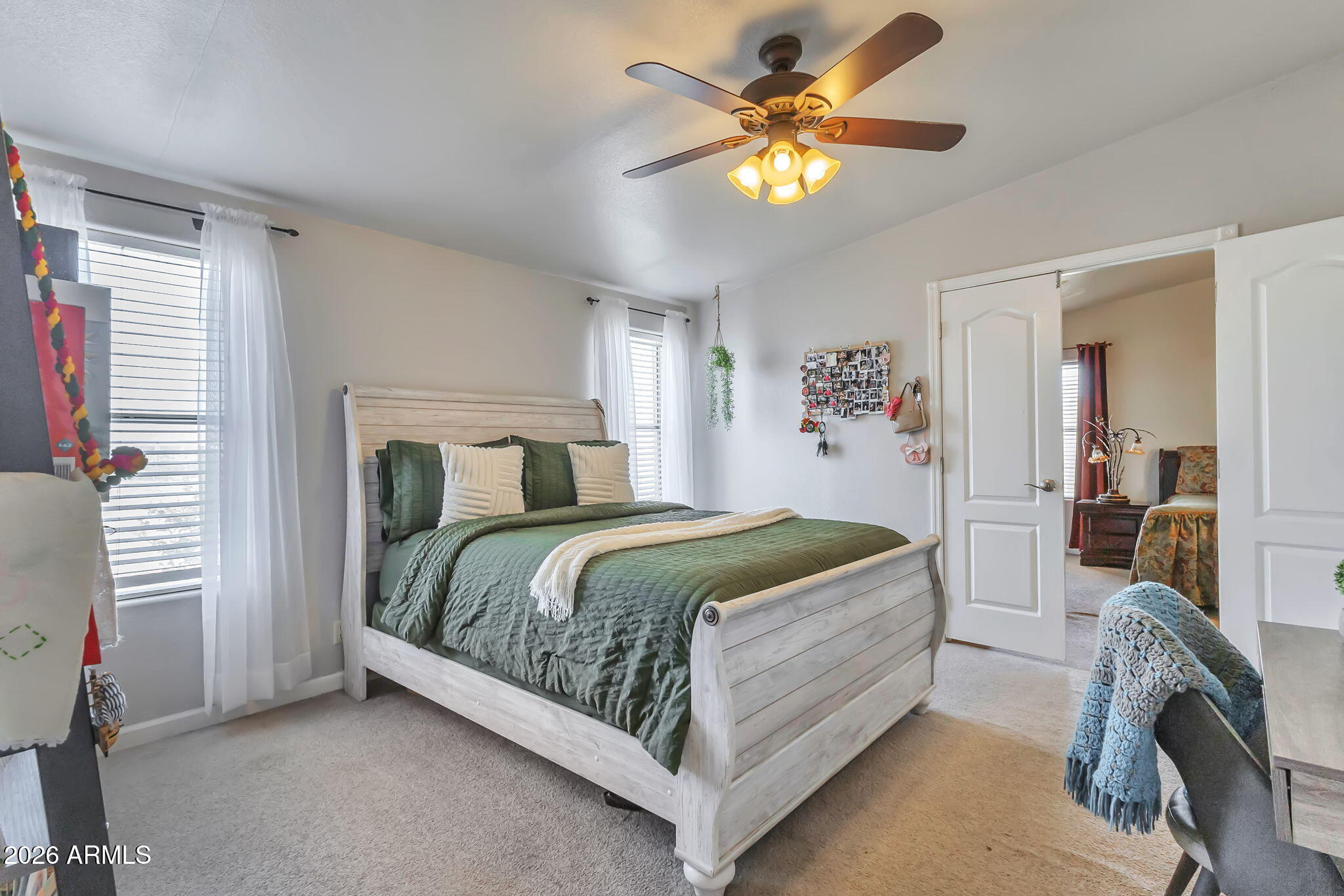 1236 West Judd Road San Tan Valley, AZ 85144 - Photo 10 of 28 a bedroom with a bed and a chandelier