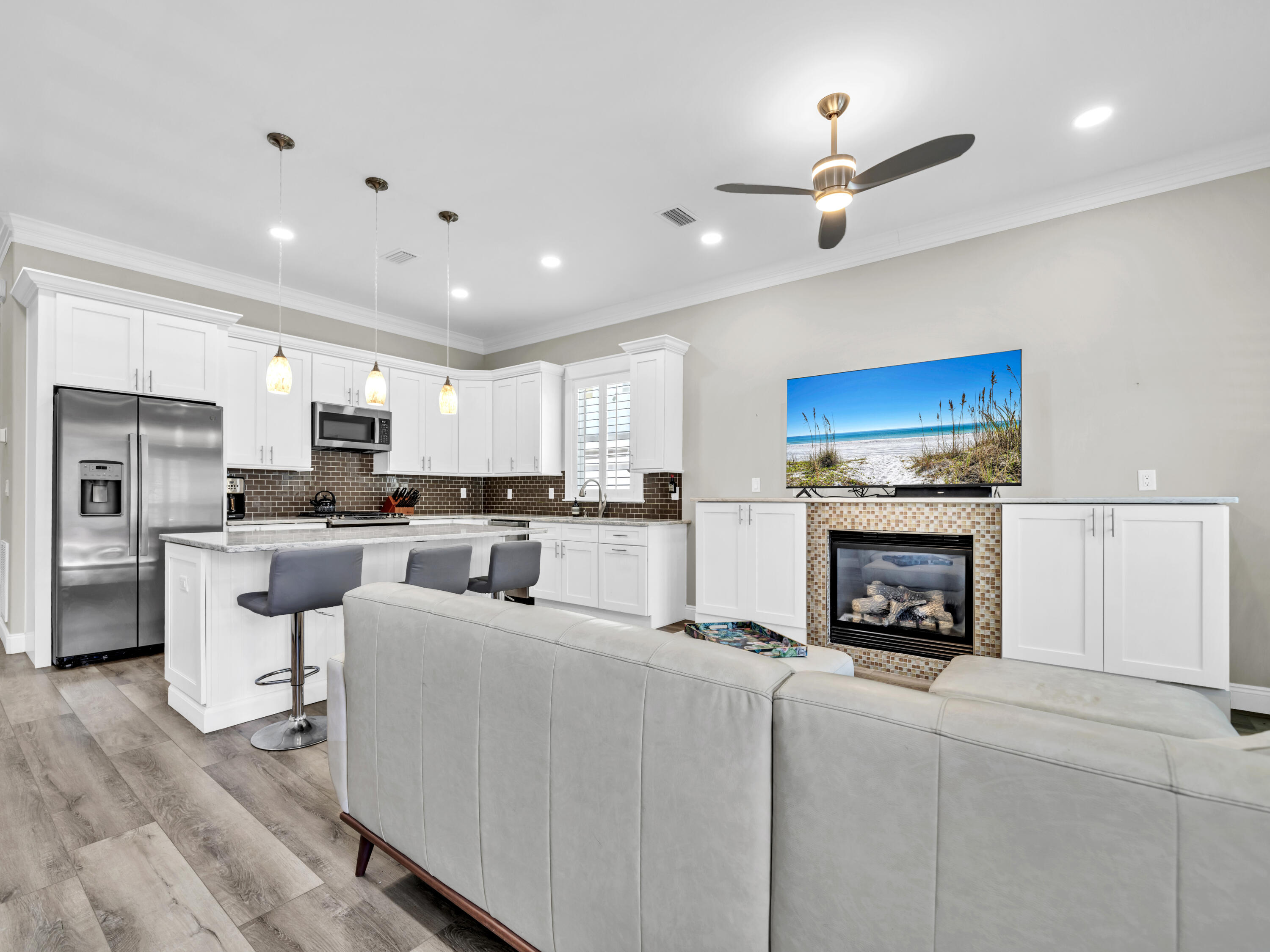 4707 Amhurst Circle Destin, FL 32541 - Photo 9 of 40 a living room with furniture a fireplace and kitchen view