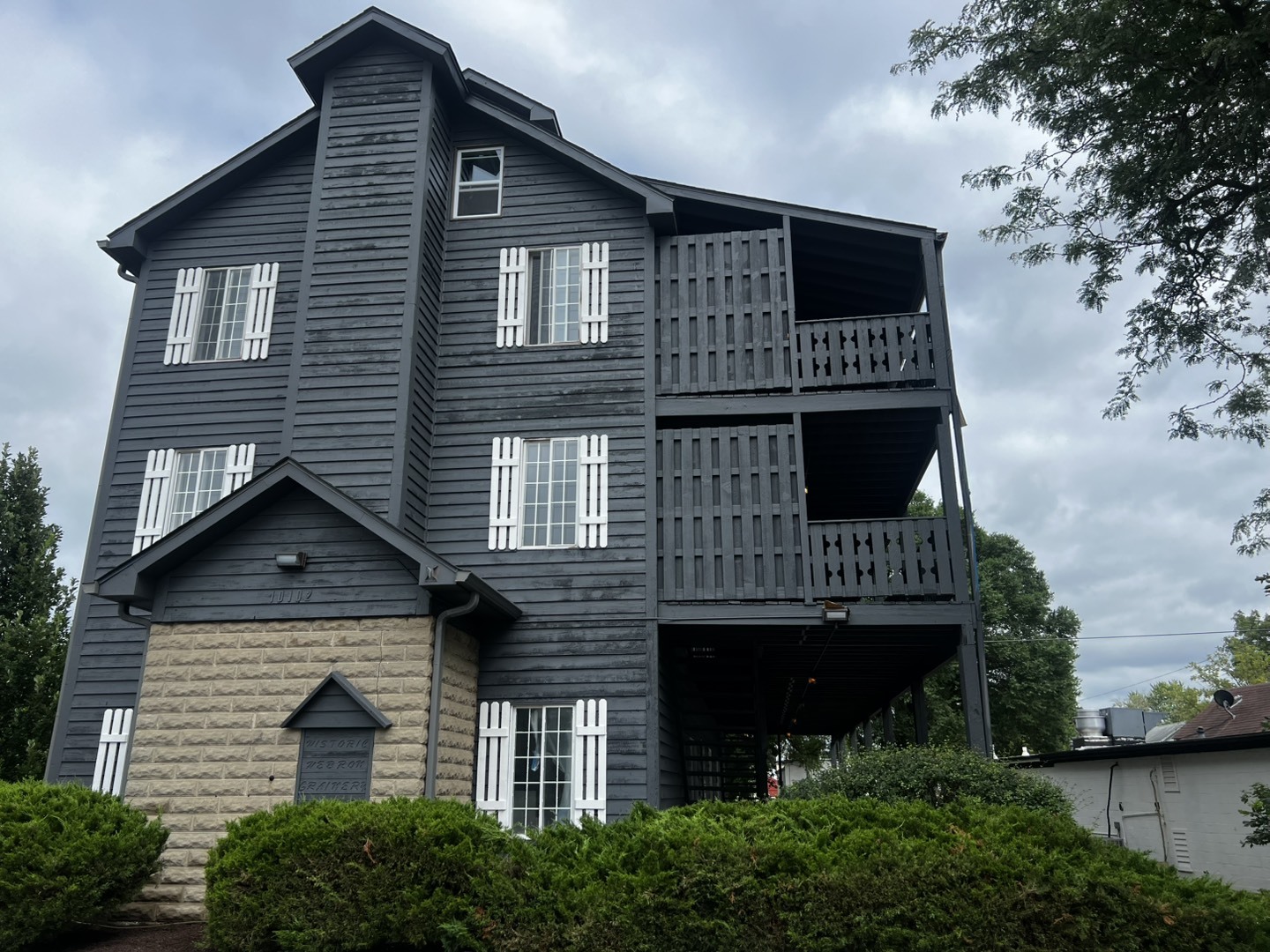 10102 Main Street, Unit 1A Hebron, IL 60034 - Photo 2 of 18 a front view of a house with plants and garage